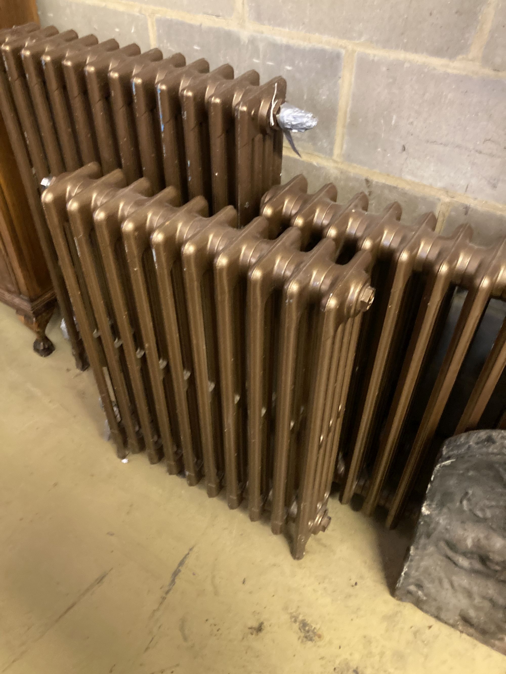 Four cast iron radiators, one vintage, three modern, largest width 64cm, height 91cm